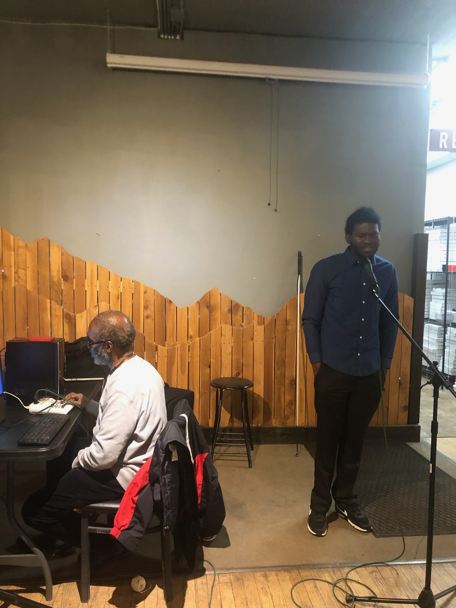 photo Johnnie J at an audio mixer and Toni Negus at the mic